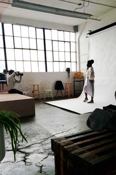 two people taking pictures in an empty room