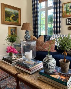 a living room filled with lots of furniture and books on top of a coffee table