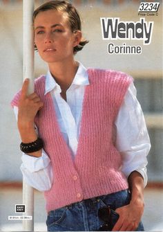 a woman wearing a pink sweater vest and white shirt is posing for the camera with her hand in her pocket