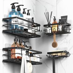 two black shelves with soaps, lotions and other bathroom items on them against a white wall