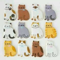 decorated cookies in the shape of cats on a white background