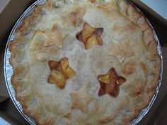 an apple pie in a box on top of a table