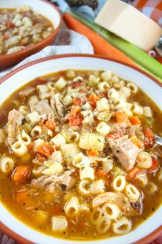 a bowl of soup with pasta and meat in it