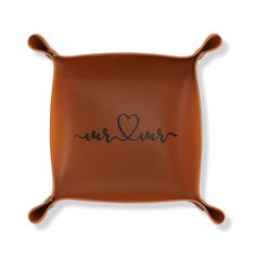 an orange leather pillow with the word mr and mrs on it, in black ink