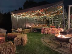 an outdoor party with hay bales and lights