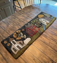 a kitchen table with a rug on top of it in the shape of a house