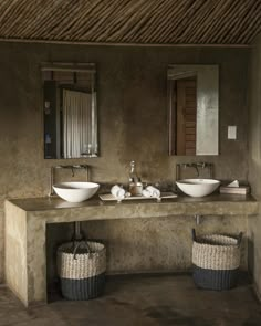 a bathroom with two sinks and baskets on the counter