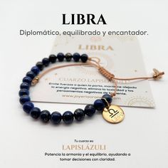 a bracelet with blue beads and a gold plated medallion on the clasp that says libra