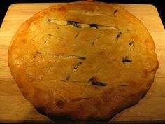 a pie sitting on top of a wooden cutting board