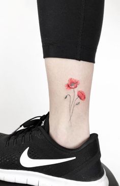 a small flower tattoo on the ankle