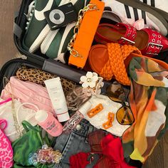 an open suitcase filled with clothes and accessories