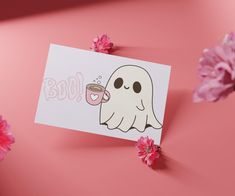 a card with a ghost holding a cup of coffee on it and pink flowers in the background