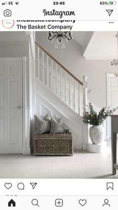 an instagram page with a basket on the floor next to stairs and a chandelier