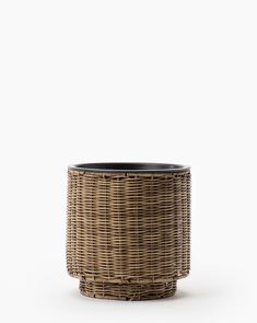 a wicker planter with black rims on a white background, the top half is empty