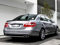 a silver car parked in front of a building