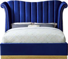 a bed with blue velvet headboard and foot board