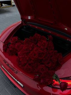 a red car with roses in the trunk