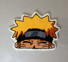 a sticker depicting a person with a hat and sun on his head, sitting against a wall