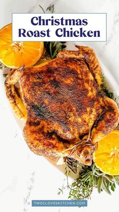 christmas roast chicken on a plate with oranges and herbs