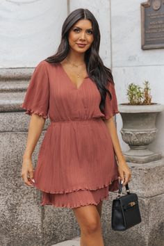 Our Baked Terracotta Satin Pleated Mini Dress exudes elegance & sophistication. The delicate pleats & tiered design create a flattering silhouette! Free US shipping! Elegant Flowy Tiered V-neck Dress, Elegant Flowy V-neck Tiered Dress, Pleated Tiered Midi Dress For Brunch, Elegant Tiered Skirt Mini Dress For Daywear, Elegant Daywear Mini Dress With Tiered Skirt, Elegant Mini Dress With Tiered Skirt For Daywear, Elegant Flowy Mini Dress With Tiered Skirt, Elegant Flowy Tiered Mini Dress, Elegant Tiered Ruffle Dress For Day Out