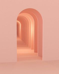 an empty hallway with pink walls and white arches leading to the light at the end