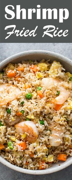 shrimp fried rice in a bowl with carrots and peas