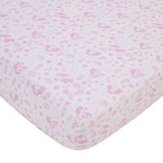 a pink and white baby crib sheet with floral designs on the bottom, along with an animal print