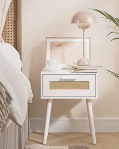 a white nightstand with a basket on top and a lamp next to it in a bedroom