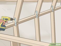 a man using a power drill to attach wood framing