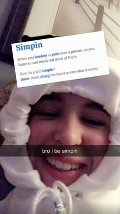 a person wearing a white hoodie with a sign on their head that says, simin