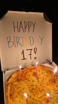 a birthday pizza with candles on it in a box