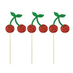 three cherries on a stick with green leaves and red glitters in the middle