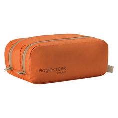 an orange toilet bag with the words eagle creek printed on it and zippered closures