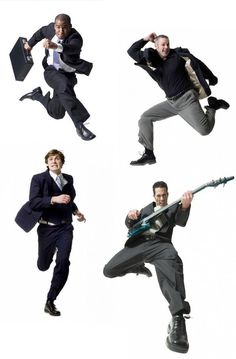 four men in suits are jumping and dancing