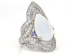 17X12mm Pear-Shaped White Lab Created Opal With .13ctw Round Blue Tanzanite And 1.70ctw Lab Created White Sapphire Rhodium Over Sterling Silver Ring. Measures Approximately 0.83"L x 1.22"W. Not Sizeable. White Multi-stone Platinum Jewelry, Gia Certified Teardrop White Ring, White Pear-shaped Jewelry With Accent Stones, Elegant Teardrop Opal Ring In Sterling Silver, Luxury Sterling Silver Opal Ring With Polished Finish, Blue Sterling Silver Opal Ring With Polished Finish, Luxury Silver Opal Ring, Hallmarked, Blue Opal Ring In Sterling Silver, Spiritual Style, White Lab