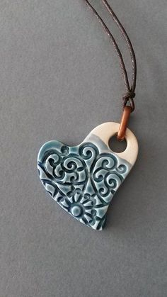 a blue and white ceramic heart on a string