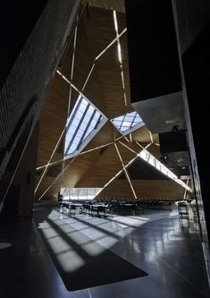 the inside of an empty building with tables and chairs in it's center area