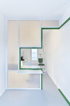 an empty bathroom with green and white accents on the walls, along with a bathtub