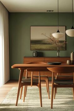 a dining room with green walls and wooden furniture in the center, along with an area rug on the floor