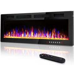 an electric fireplace with fire and flames on the side, next to a remote control