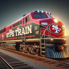 a red and black train traveling down tracks next to a sky filled with clouds at night