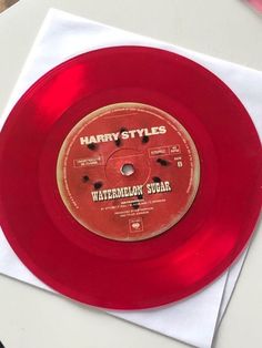 a red record sitting on top of a white table