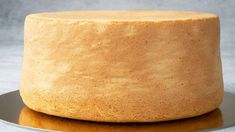 a round cake sitting on top of a metal plate