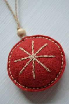 a red ornament hanging from a string