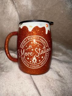 there is a red coffee mug with white frosting on the bottom and words more station