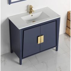 a white sink sitting under a mirror next to a blue cabinet