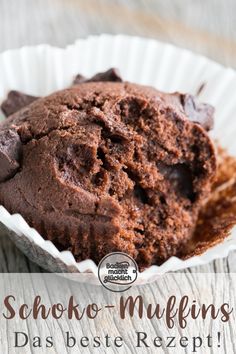 a chocolate muffin in a paper cup on top of a wooden table with text overlay