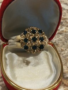 This 18K yellow gold ring is from northwest Indiana. I'm the third owner. The original owner sold it to a dealer, who called me to look at this awesome ring. Of course, I ended up buying it. It's 6.6 or 6.7 grams of 18k gold, and is stamped inside the ring. (My gram scale keeps fluctuating back and forth). There are 9 round genuine sapphires that are a medium blue. They aren't the dark, inky looking stones. They are roughly 3 mm each, but they are all slightly different. I'll call it roughly a c Collectible Round Sapphire Ring With Diamond Cut, Collectible Sapphire Ring With Diamond Cut, Victorian Cluster Jewelry For Formal Occasions, Gold Sapphire Ring With Diamond Cut For Formal Occasions, Gold Costume Jewelry Ring For Anniversary, Vintage Gold Sapphire Ring With Round Cut, Victorian Gold Sapphire Ring For Formal Occasions, Formal Gold Sapphire Ring With Diamond Cut, Gold Victorian Sapphire Ring For Formal Occasions