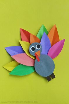 a paper turkey on a green background