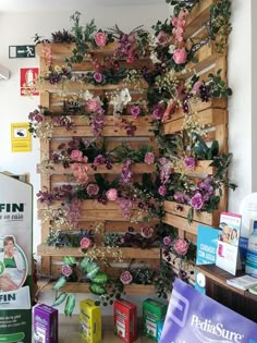 the wall is covered with flowers and plants